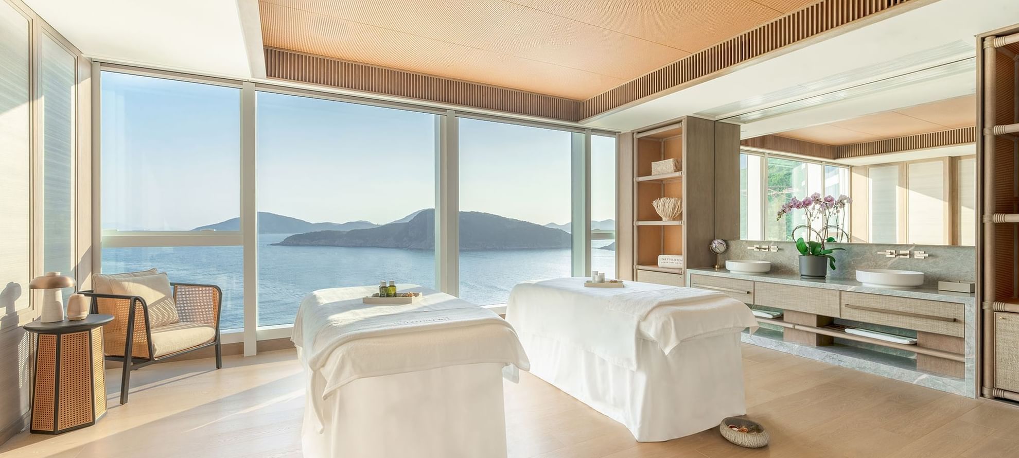 Two massage beds by the large window in The Fullerton Spa at Fullerton Ocean Park Hotel Hong Kong