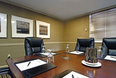 Boardroom table with notepads & chairs at Ethan Allen Hotel