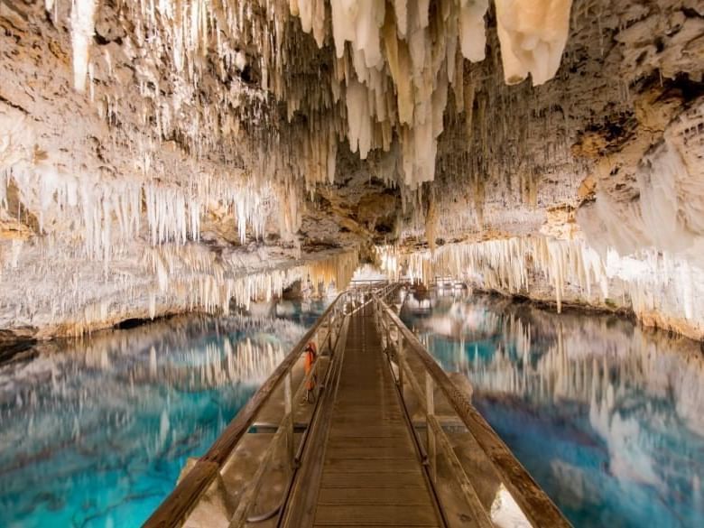 A water-lined walkway  in Crystal Caves near Royal Palms Hotel