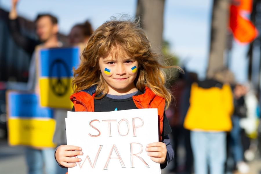 Girl holding a Stop War poster at The Originals Hotels