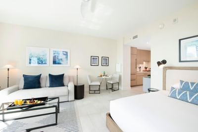 Cozy seating area and dining table by the bed in S303 Room at The Residences at Seafire