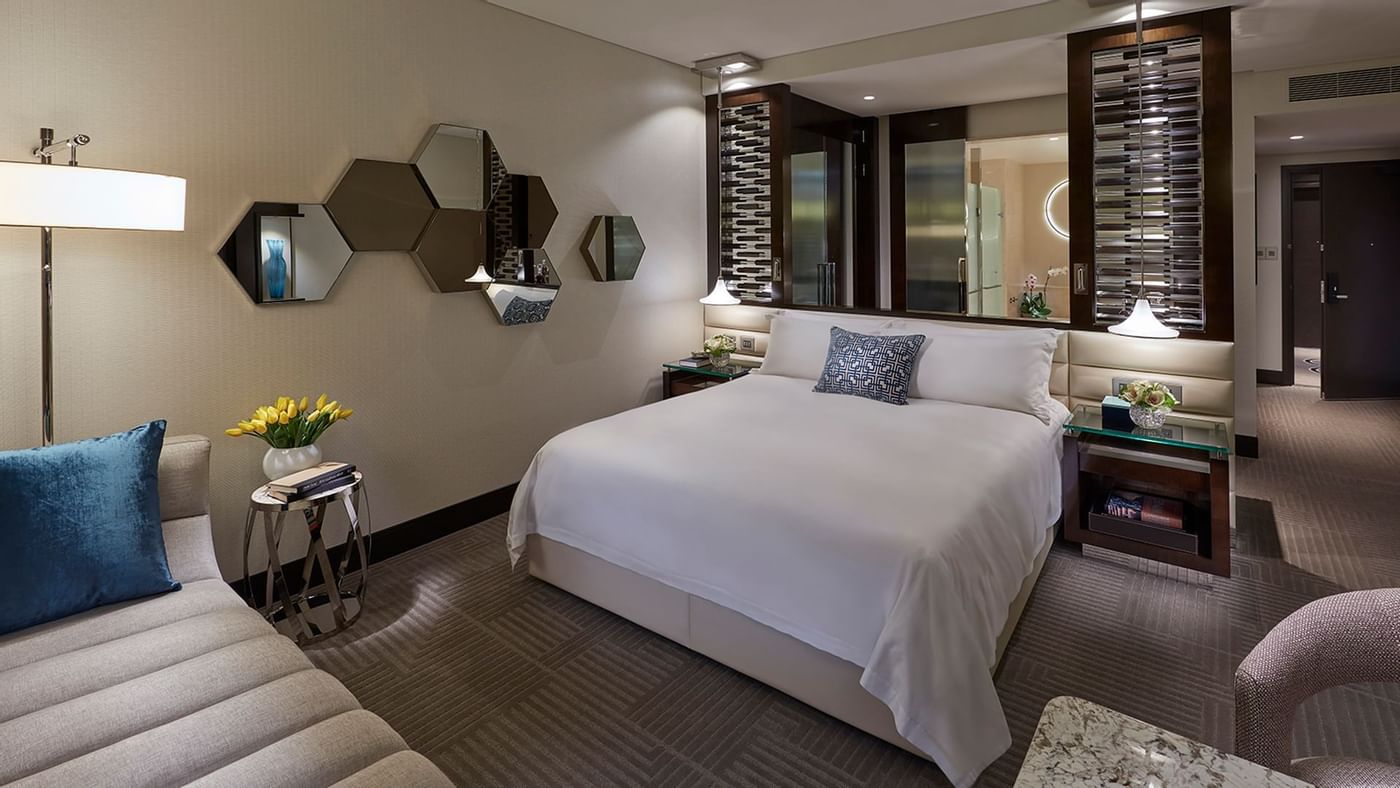 Bed & furniture in Deluxe King Room at Crown Hotels