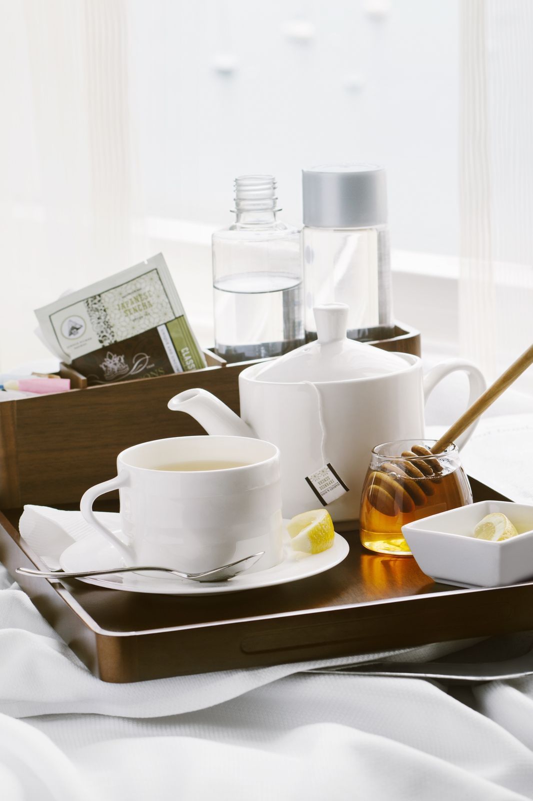 Tea and honey on a wooden serving tray