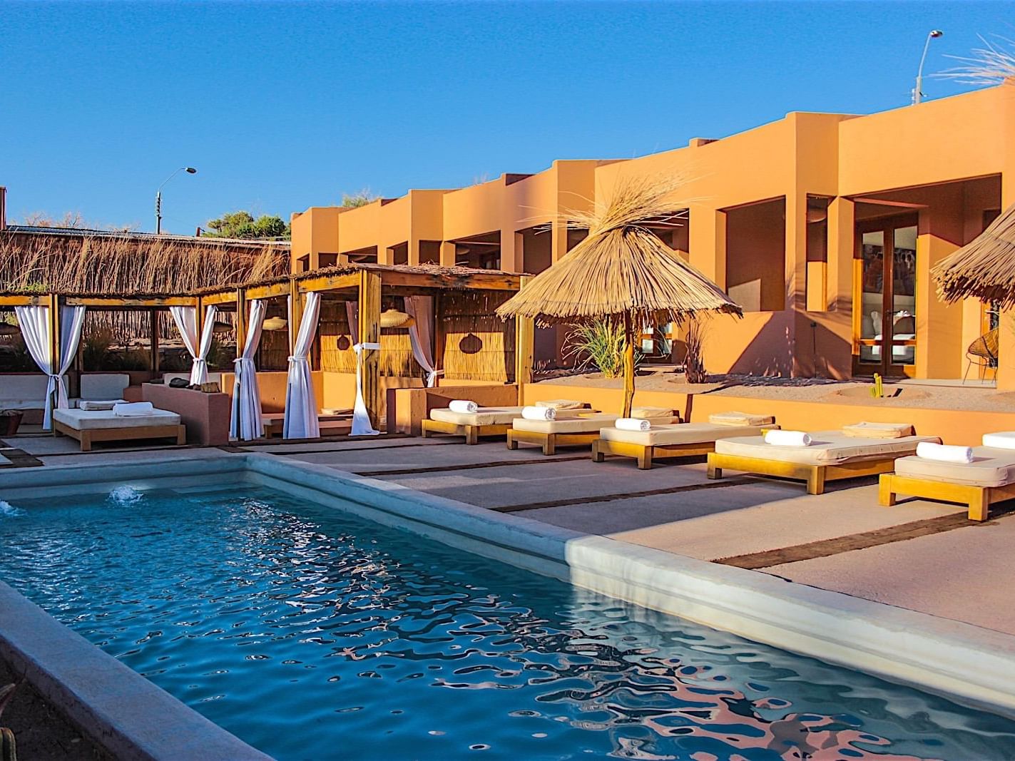 outdoor pool with lounging area at NOI Casa Atacama Hotel