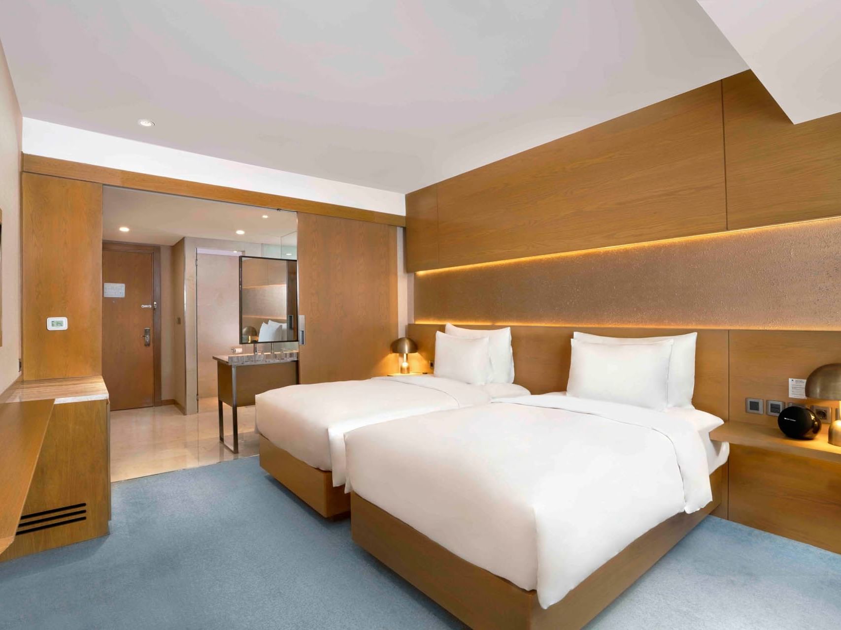 Twin beds with lamps in Premium room at Vasa Hotel Surabaya