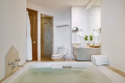 A sophisticated deep soaking tub seamlessly integrated into an upscale resort suite layout.