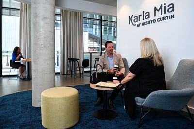 Couple lounging in the hotel lobby at Nesuto Curtin Perth Hotel