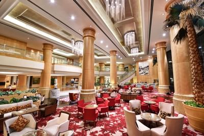 Sphere Lounge featuring white & red themed interior with large chandeliers at One World Hotel