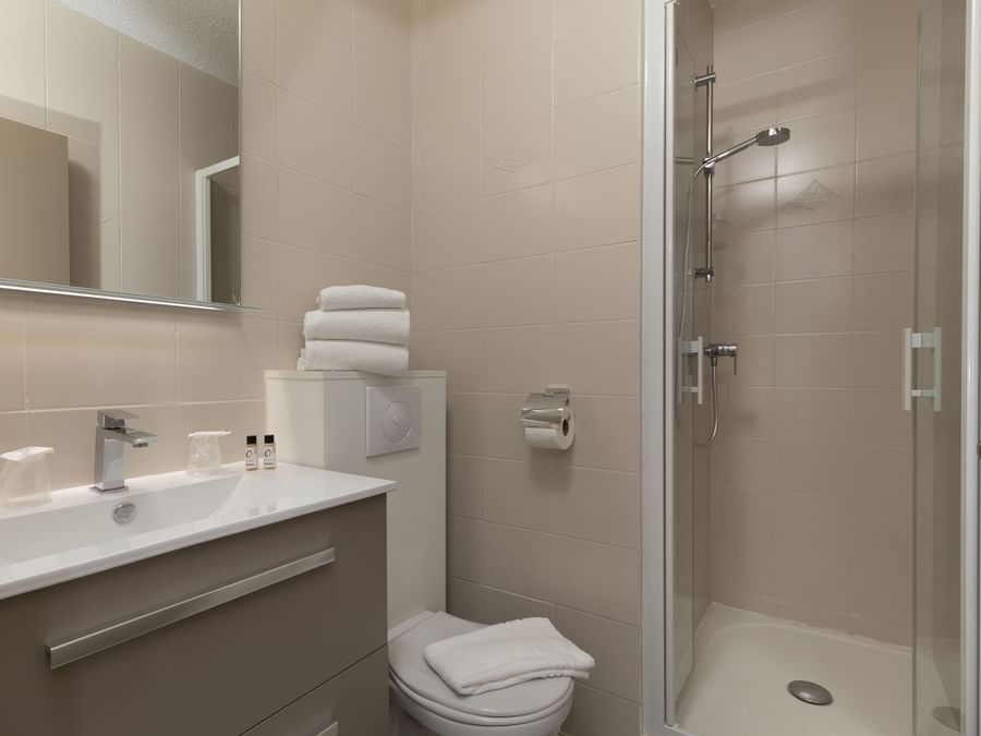 Bathroom shower & vanity area in a room at relax otel