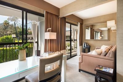 Comfy sofas turned towards the garden in Executive Junior Suite at Luxe Sunset Boulevard Hotel