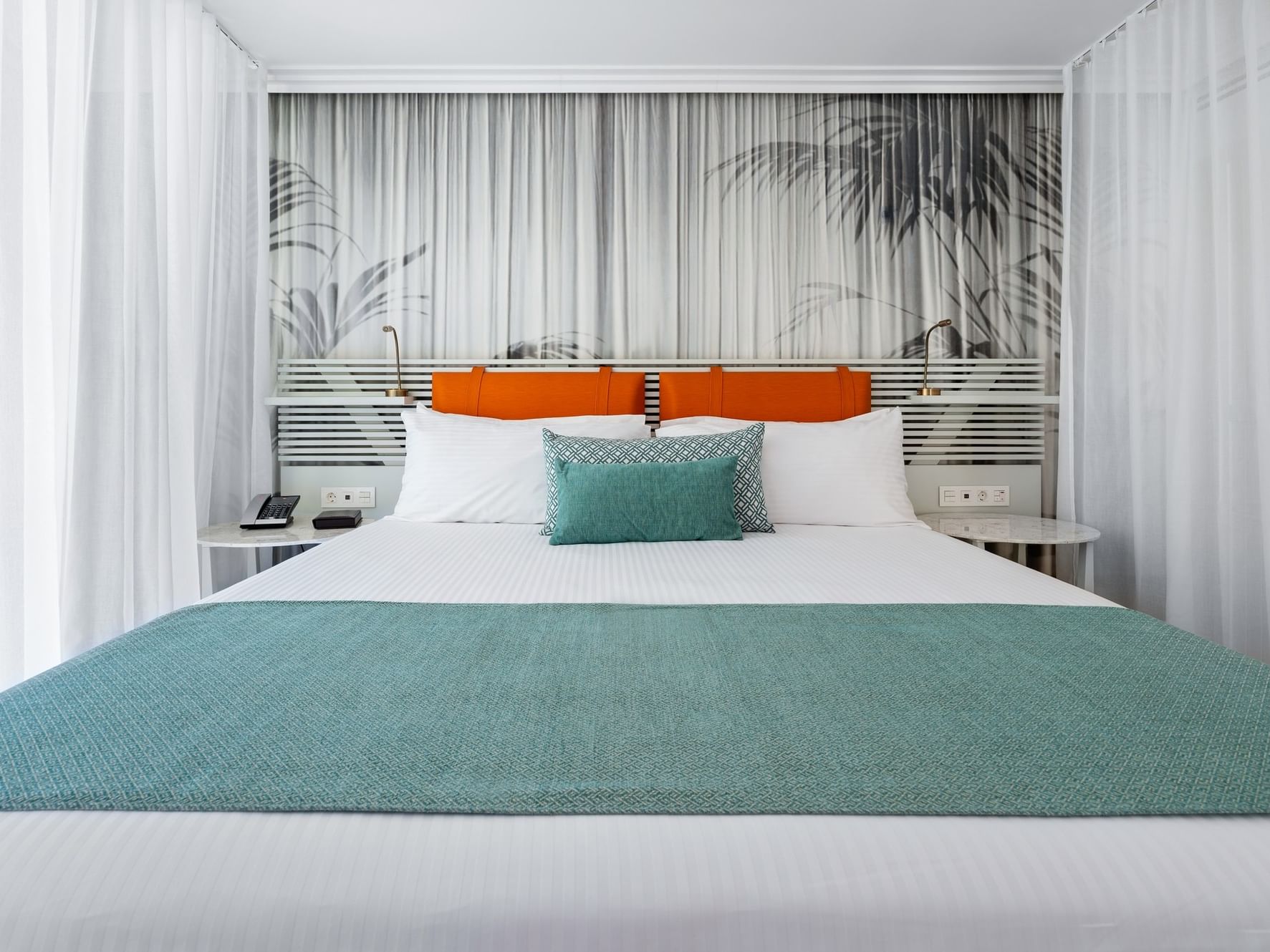 King Bed Suite with nightstands & botanical wall print at St. Martin Beach Resort, featuring St. Martin all inclusive resorts