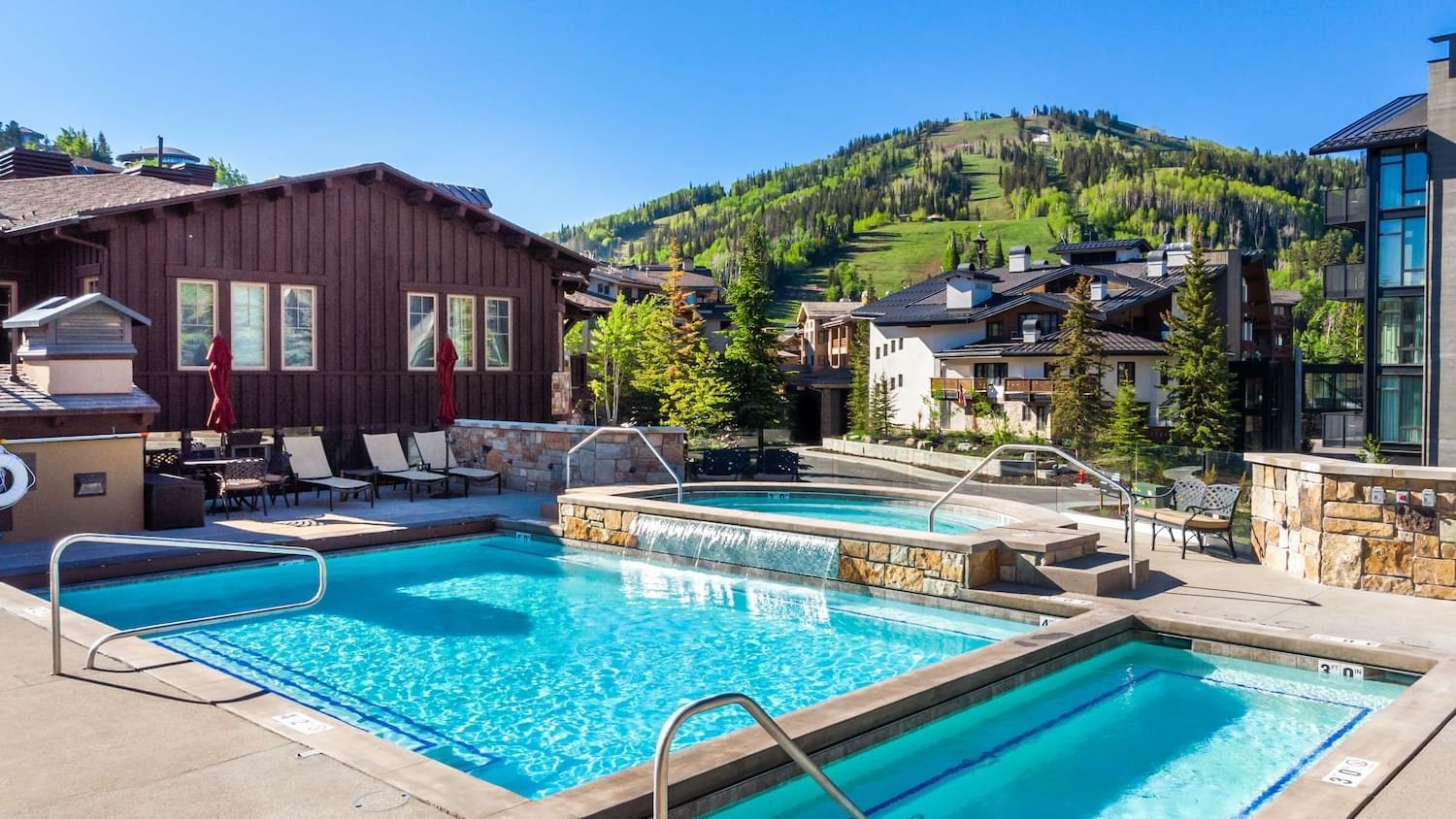 Heated Pools with Hot tub arranged with loungers at Chateaux Deer Valley
