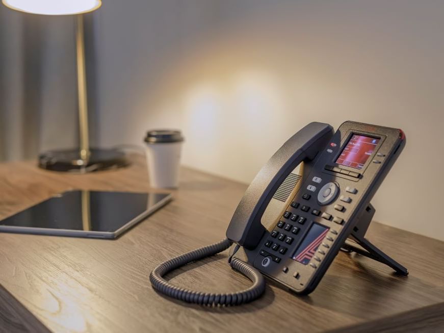 Lamp, iPad, coffee and telephone on desk
