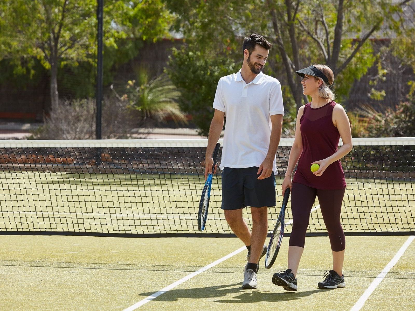 Couple playing tennis in the court at Pullman Bunker Bay Resort