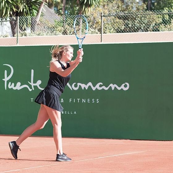 A tennis player playing in a tennis court at Marbella Club