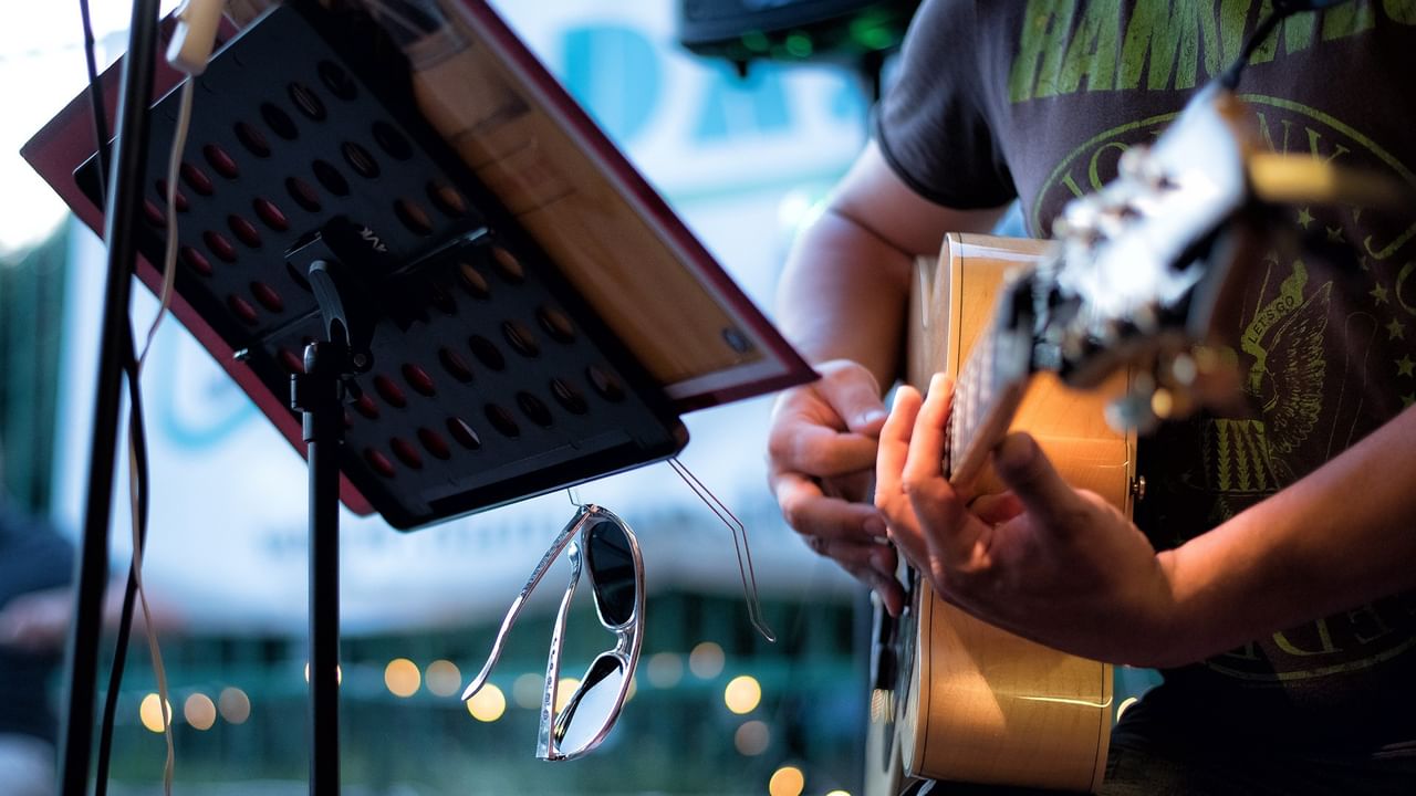 Person playing guitar outdoors
