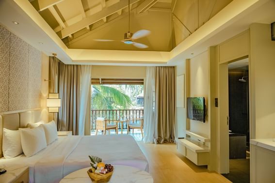 Bed & balcony in Deluxe Pool Terrace Room at Pelangi Resort