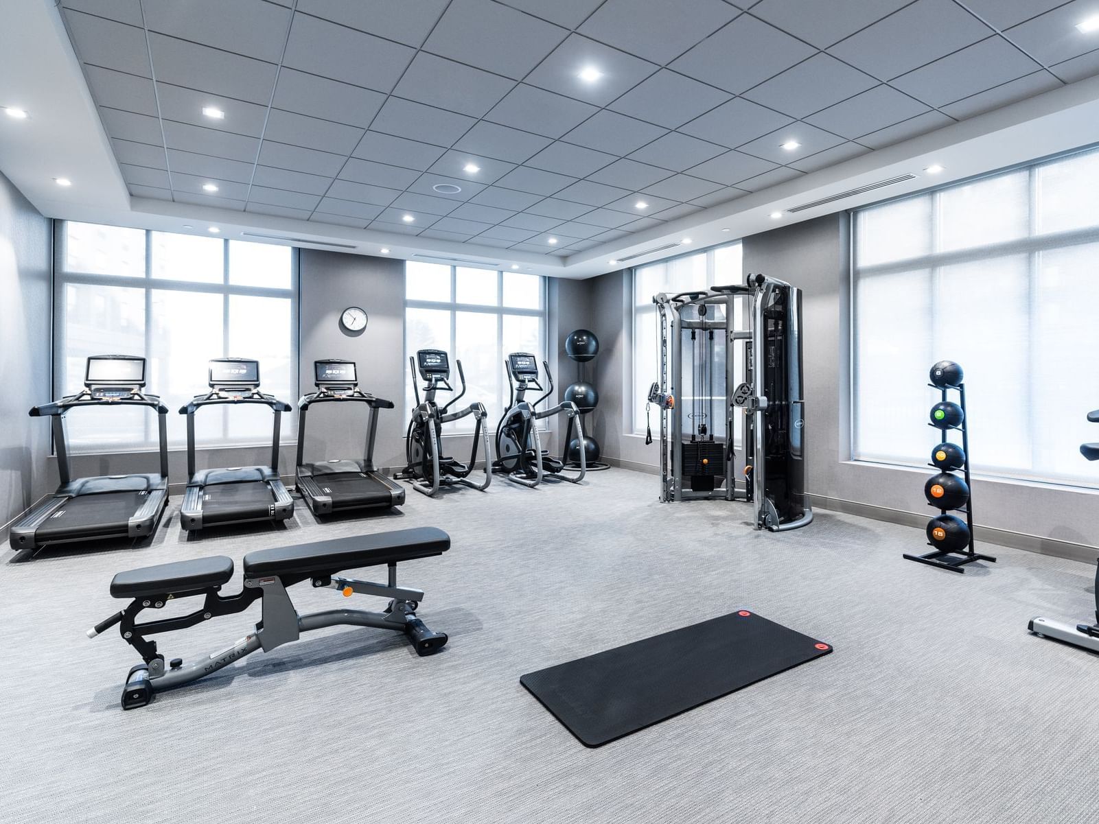 fitness center with treadmills, medicine balls and other workout equipment
