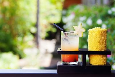 Close-up of a tropical inspired welcome cocktail served with a warm towel at Accra Beach Hotel & Spa