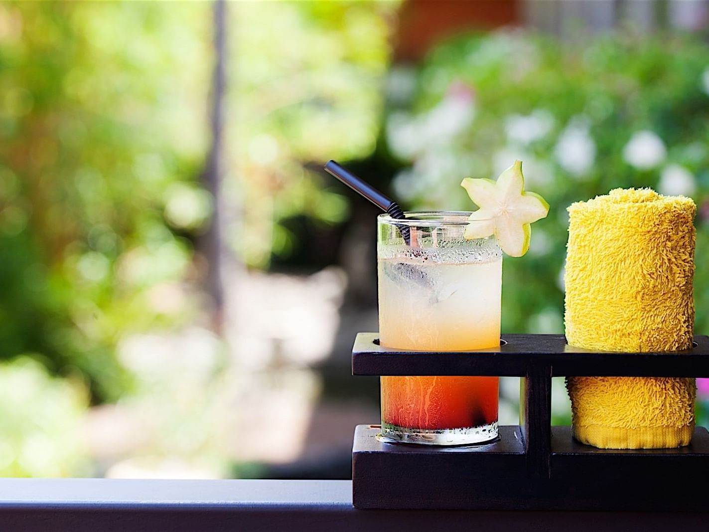 Close-up of a tropical inspired welcome cocktail served with a warm towel at Accra Beach Hotel & Spa