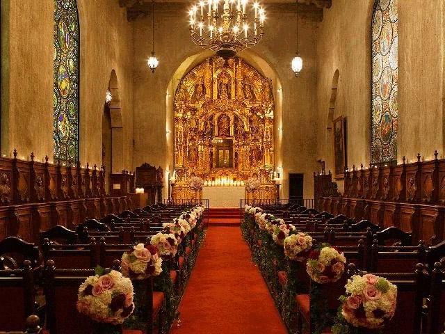 Aisle to altar lined with flowers at Mission Inn Riverside