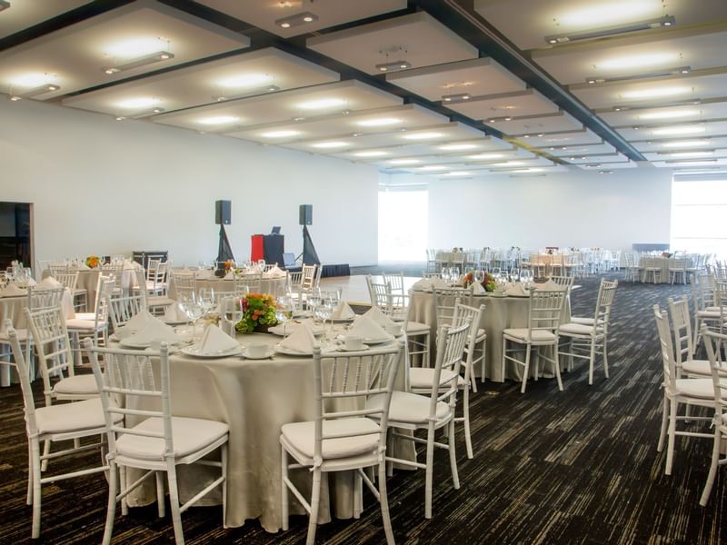 Event hall with banquet setup at Fiesta Inn Hotels
