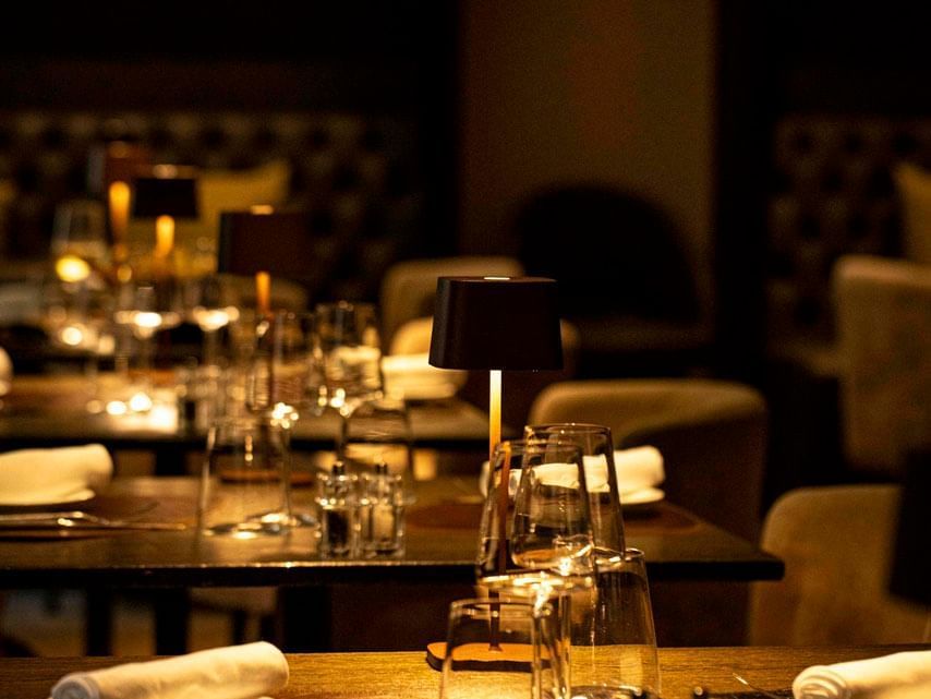 An indoor dining table arranged with cutlery at EMME Restaurant