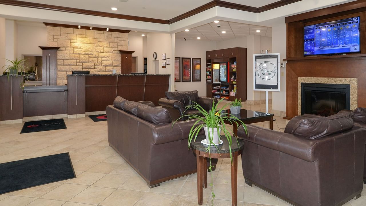 Coast Weyburn Hotel Lobby with couches and a tv