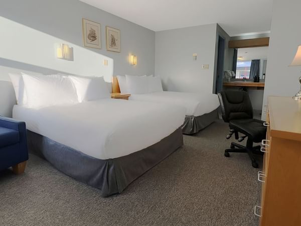 Two double beds, a chair and a work desk