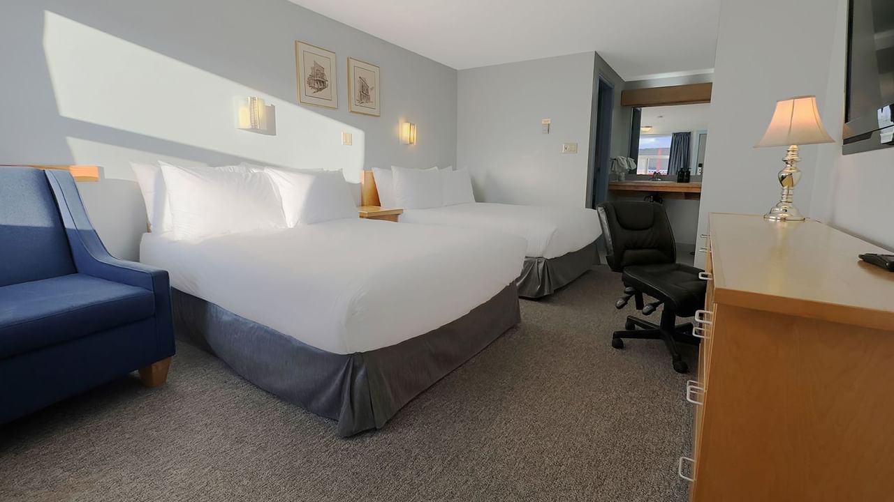 Two double beds, a chair and a work desk