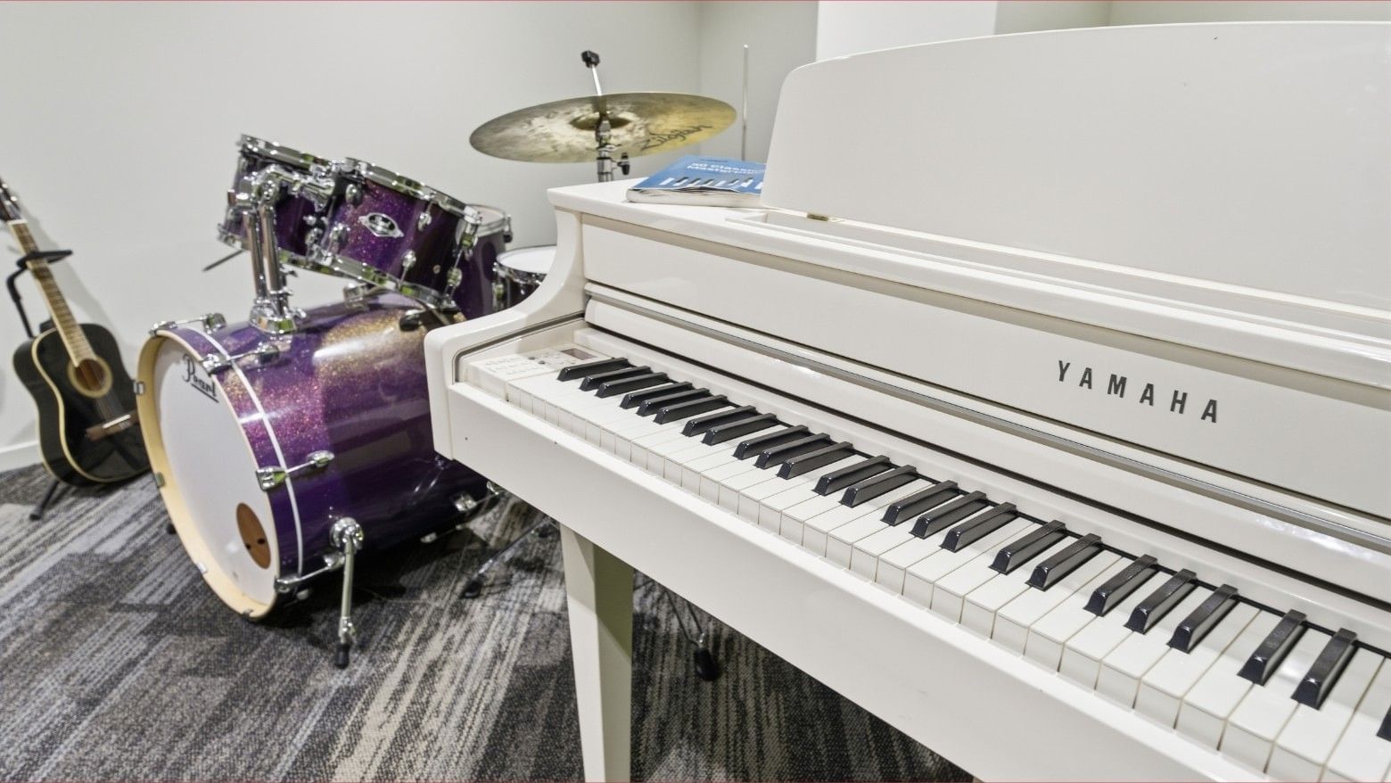 Yamaha piano with drums and guitar at Mayoral Drive Student Accommodation.