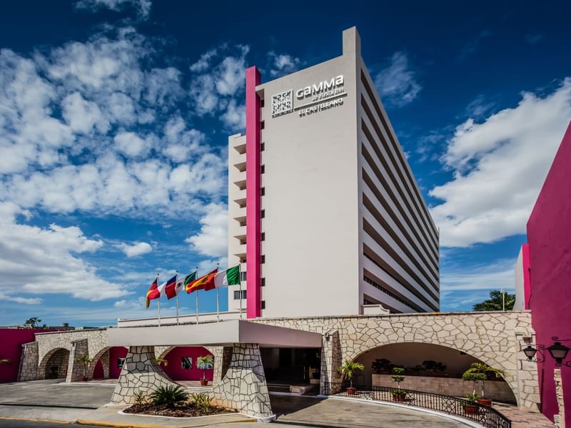 Exterior view of the hotel entrance with flags at Gamma Hotels