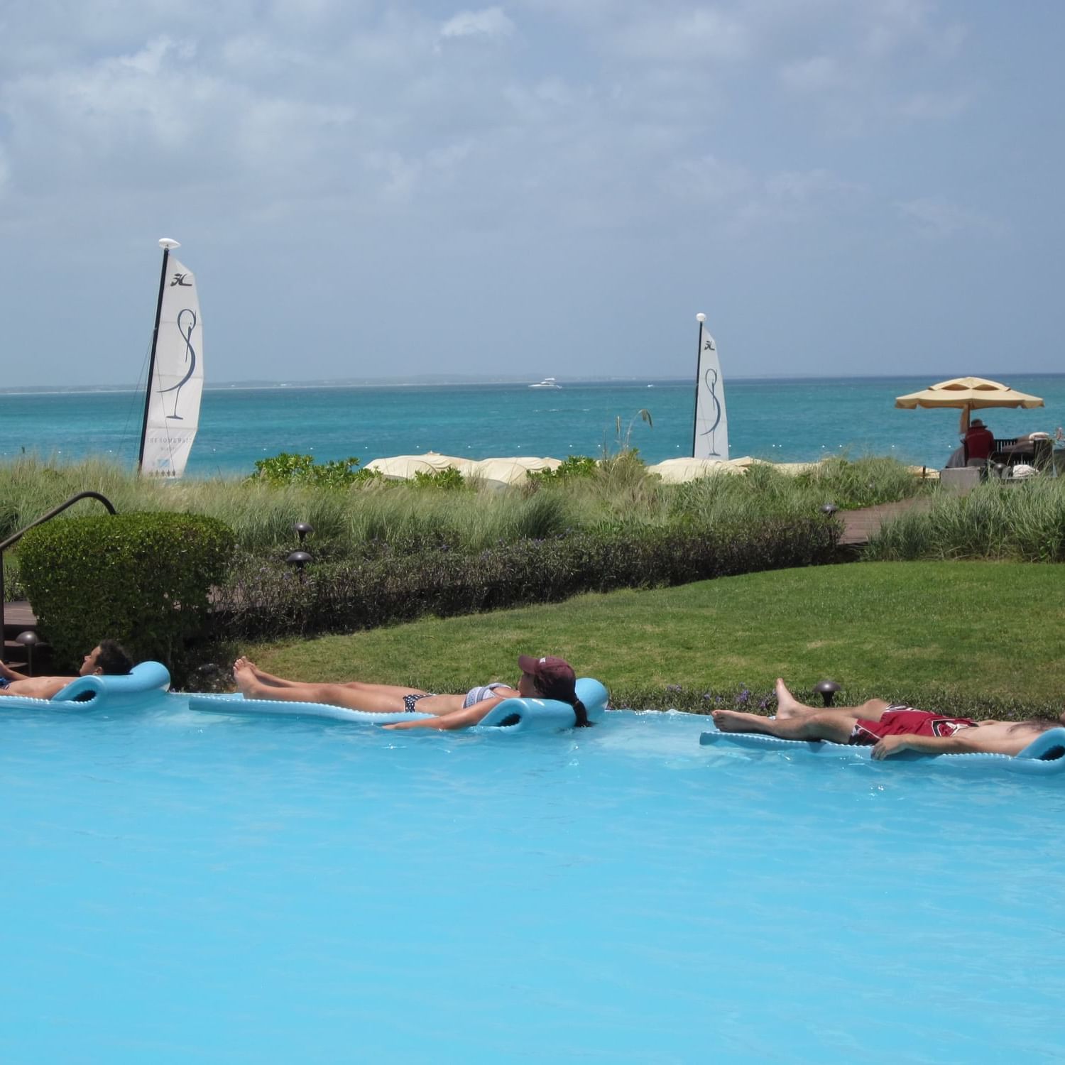 People relaxing by the pool at The Somerset on Grace Bay