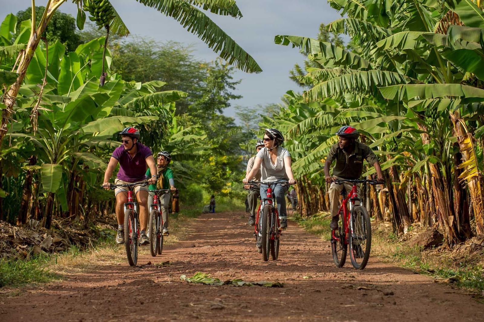 People riding bikes in a farm near Lake Manyara Serena Lodge