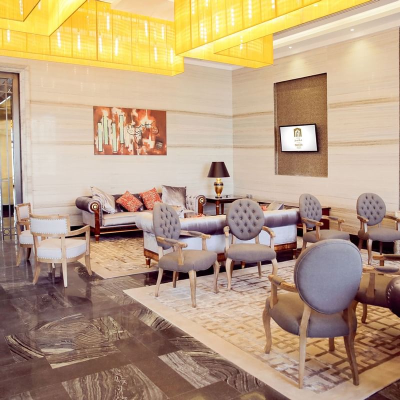 Luxury interior of the lobby area with comfy seats at Naviti By Warwick Dammam