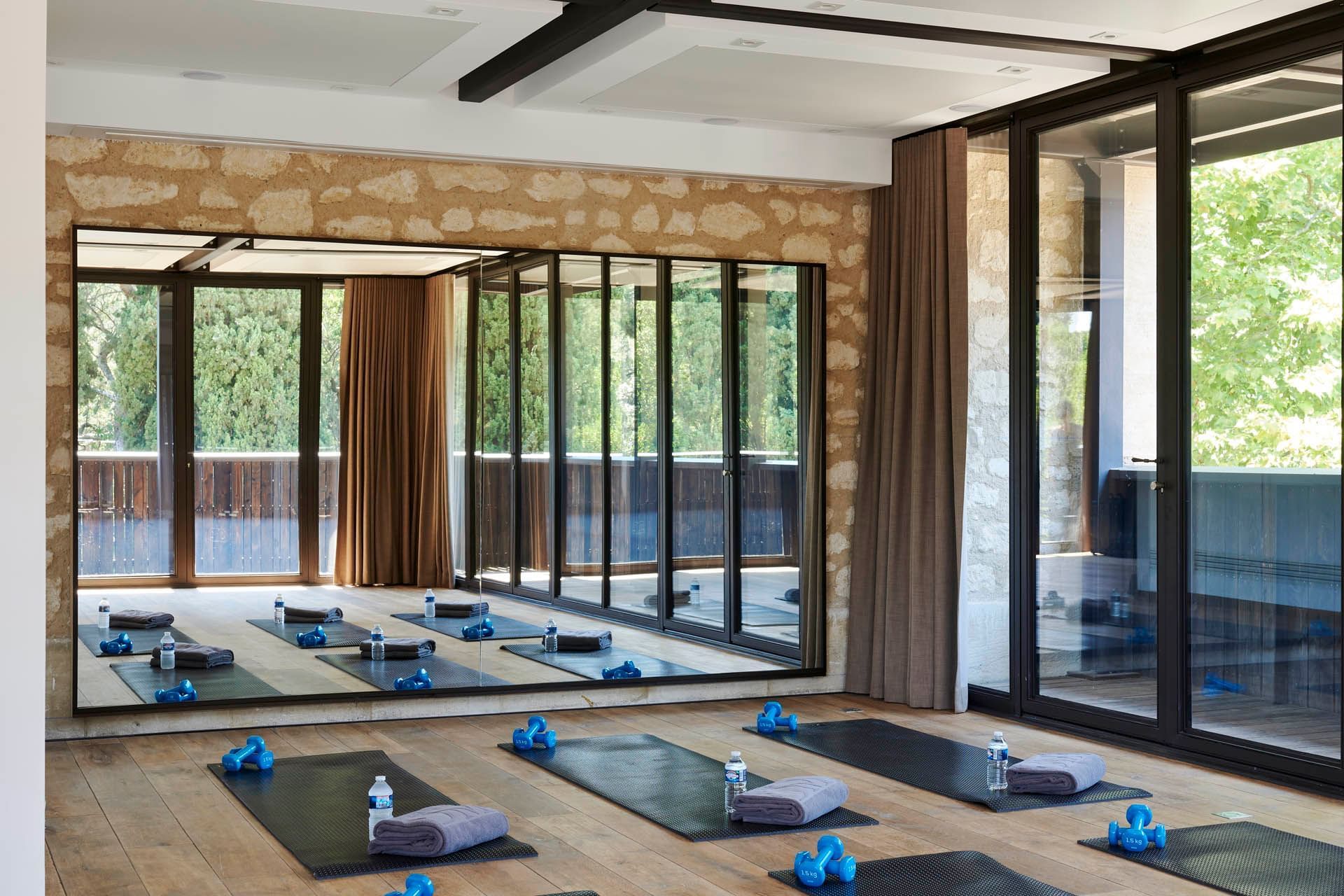 Bottle, towel, equipment on yoga mat at Domaine de Manville