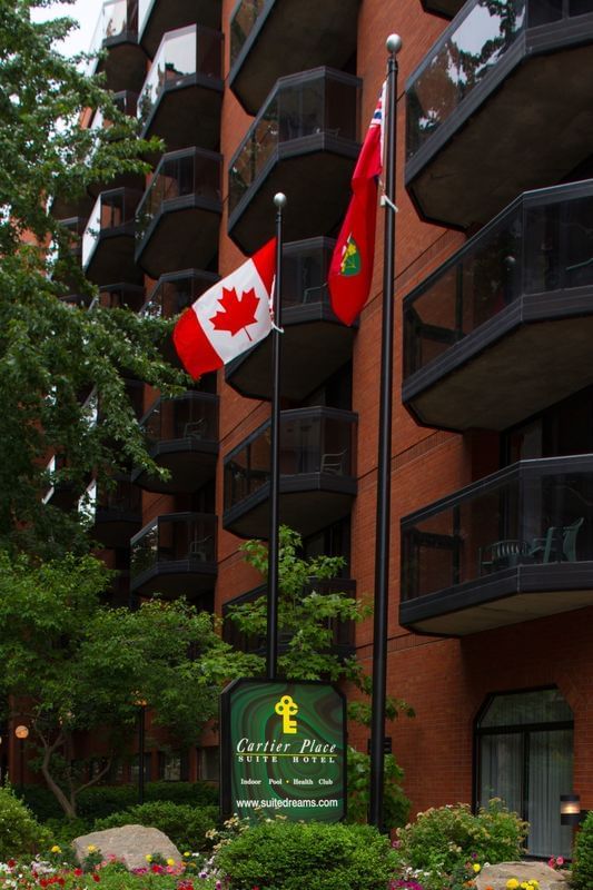 Canadian flag by the entrance of Cartier Place Suite Hotel