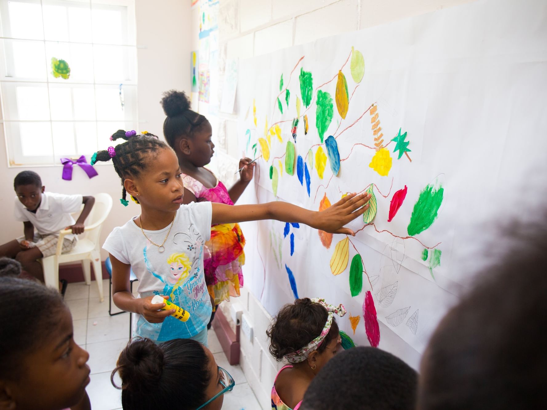 Kids engaging in a wall art near True Blue Bay Resort