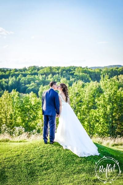Bride & groom kissing near Hotel Mont Gabriel Resort & Spa