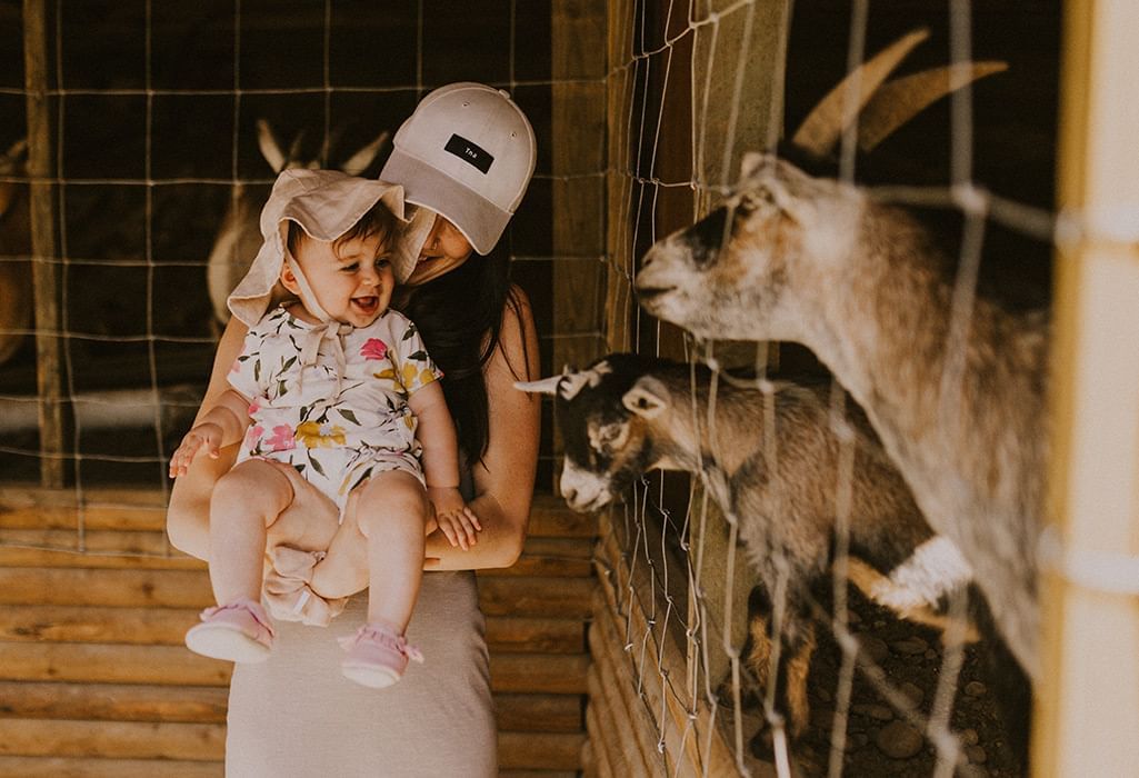 women and child with baby goats