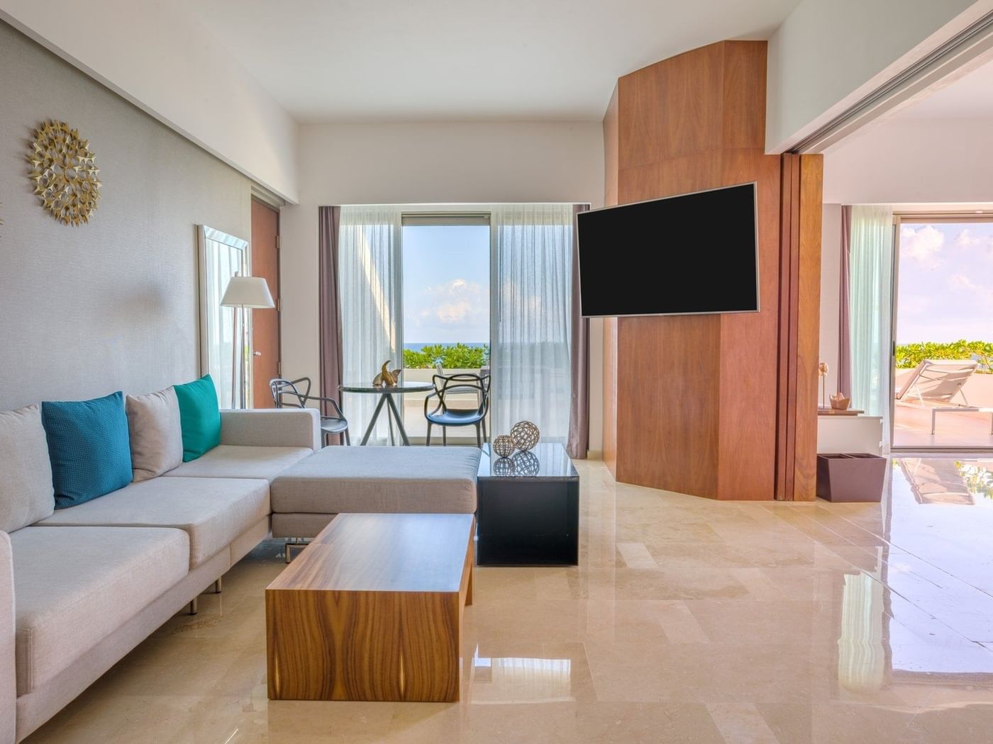 Aqua suite's living room area with TV at Live Aqua Beach Resort Cancun