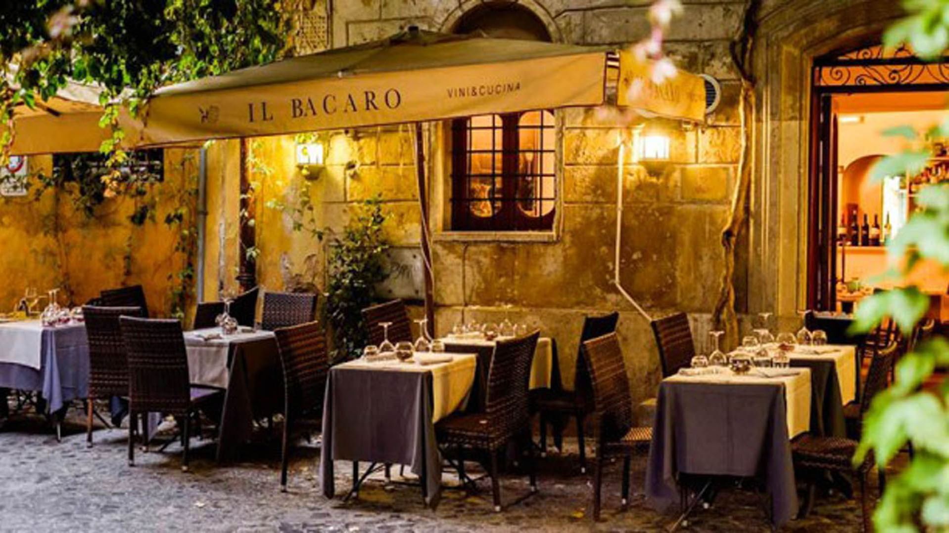 Outdoor dining area in Il Bacaro Restaurant at night near Rome Luxury Suites