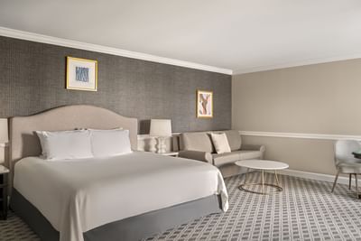 King bed with sofa in presidential suite at The Madison Hotel