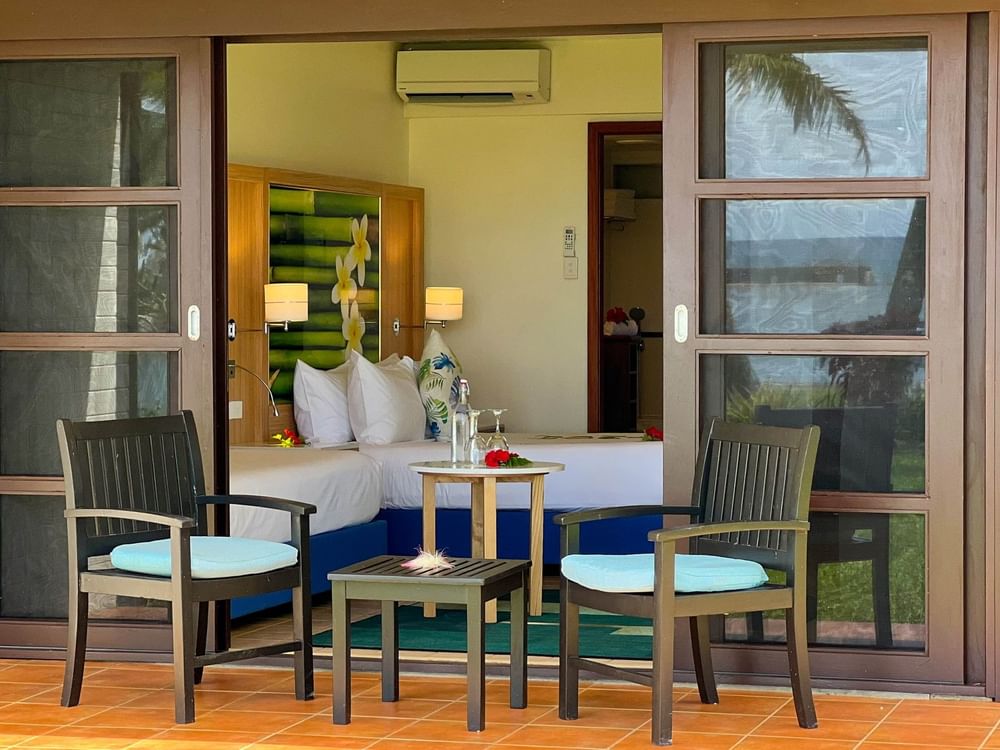 Ocean View Room patio with two chairs and table at The Naviti Resort in Korolevu.