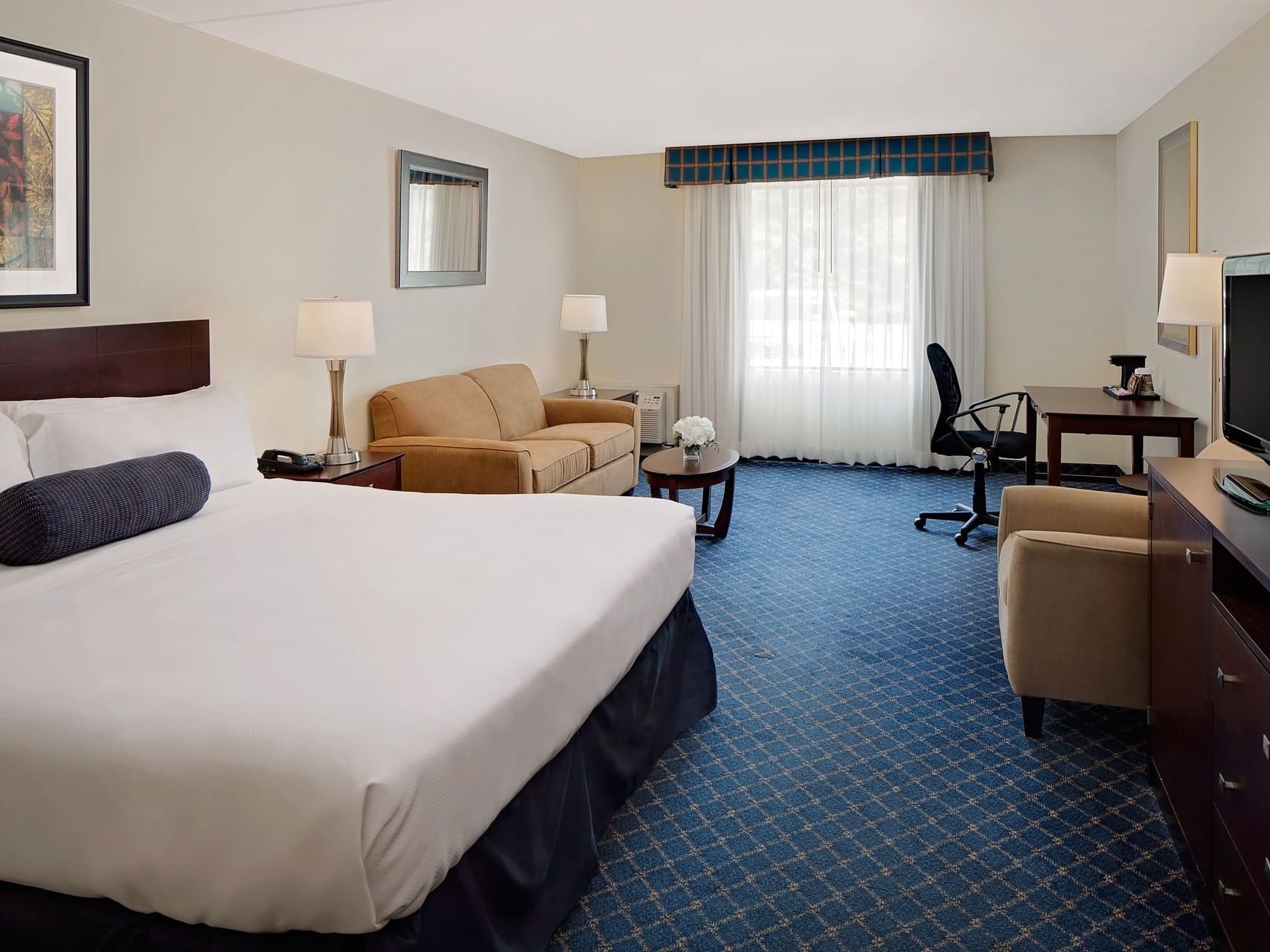 King bed, couch & work table in Junior Suite at Boxboro Regency