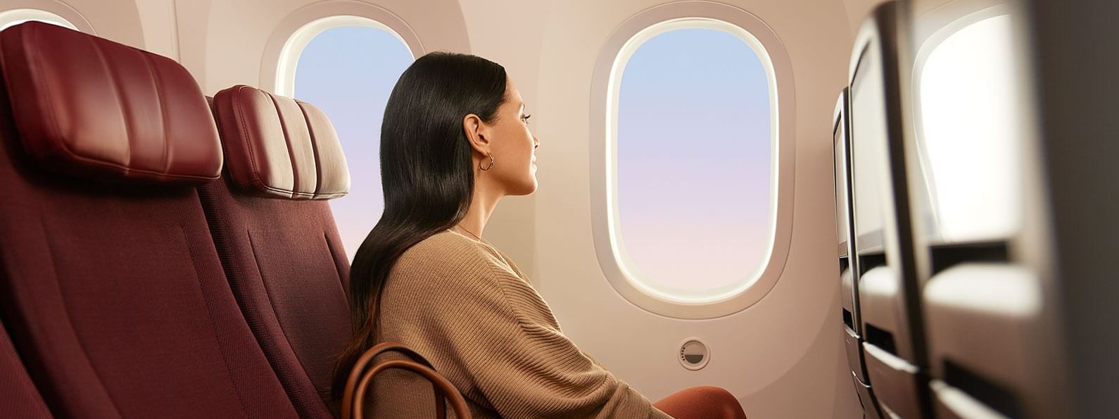 Lady sitting in an airplane seat, gazing out the window near Novotel Sydney Olympic Park