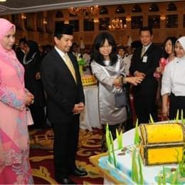 People gathered to cut a cake at  Federal Hotels International