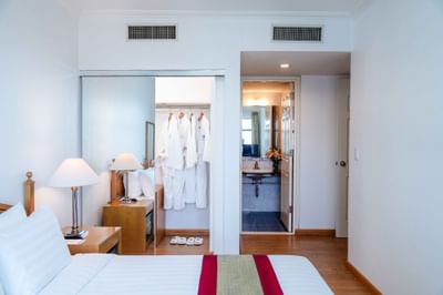 Luxury room with bed, dresser & a mirror at Hanoi Daewoo Hotel