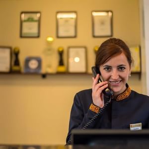 Closeup of the receptionist on a call at Dushanbe Serena Hotel