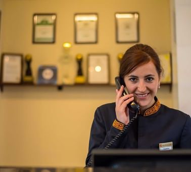 Closeup of the receptionist on a call at Dushanbe Serena Hotel